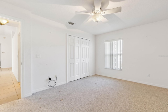 unfurnished bedroom with a closet, ceiling fan, and light colored carpet