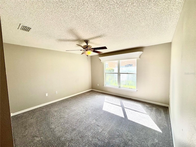 carpeted spare room with a textured ceiling and ceiling fan