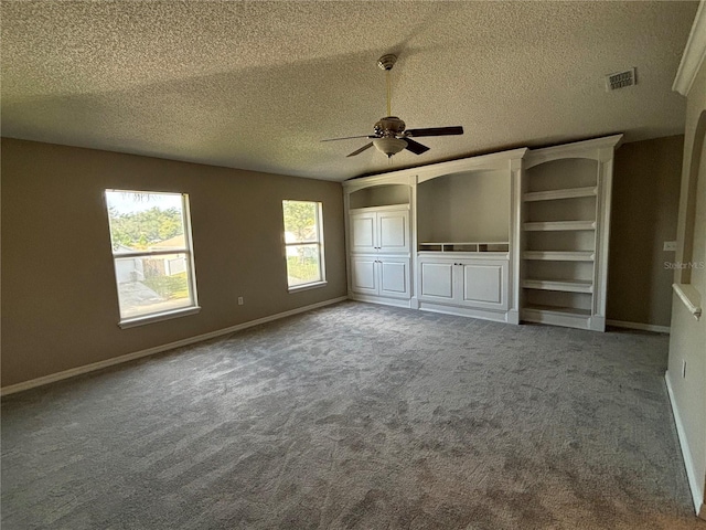 unfurnished living room featuring a textured ceiling, carpet, and ceiling fan