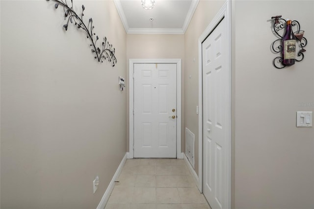 entryway with ornamental molding and light tile patterned flooring