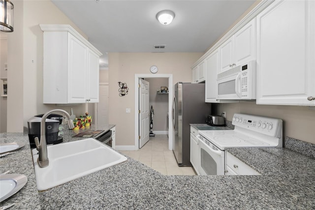 kitchen with sink, white cabinetry, white appliances, and light tile patterned flooring