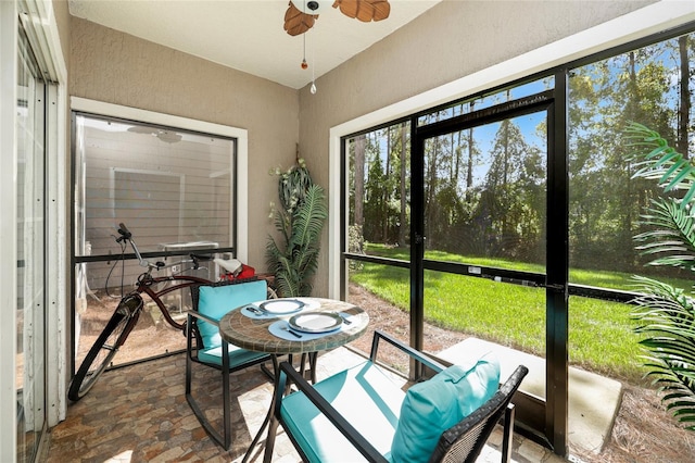 sunroom / solarium featuring ceiling fan