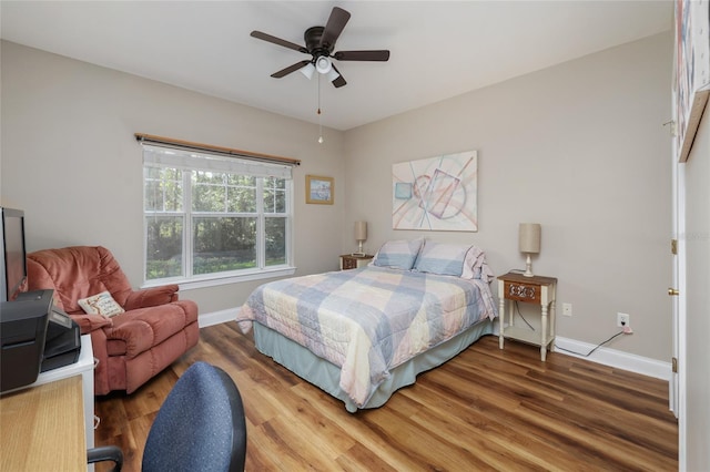 bedroom with hardwood / wood-style floors and ceiling fan