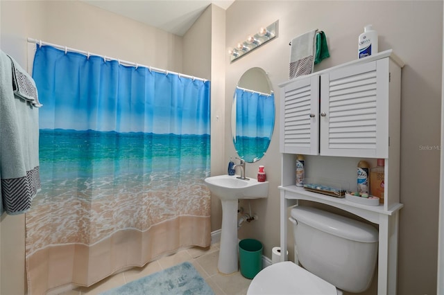 bathroom with toilet and tile patterned floors