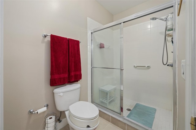 bathroom featuring toilet, walk in shower, and tile patterned flooring