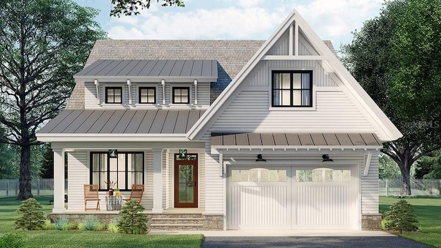 view of front of property with a porch, a front lawn, and a garage