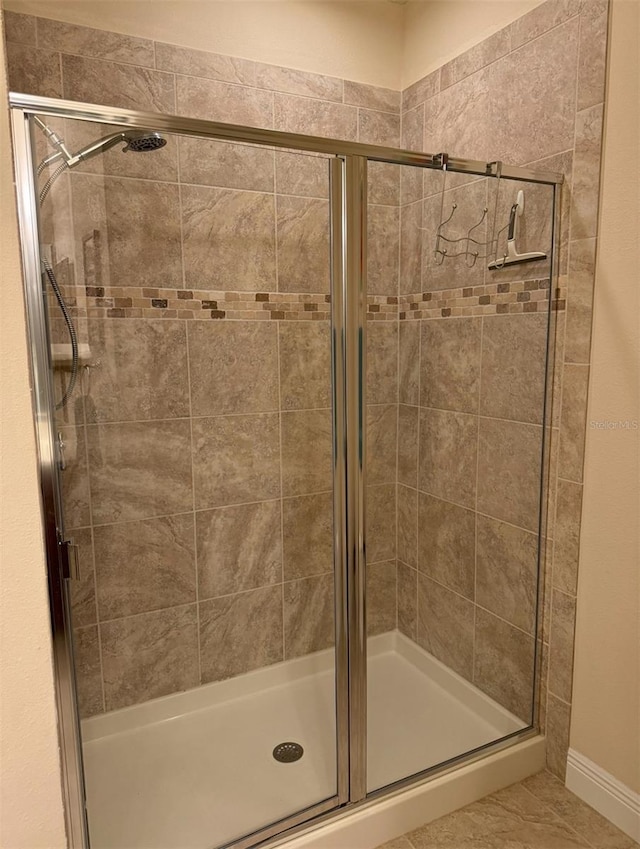 bathroom featuring a shower with shower door