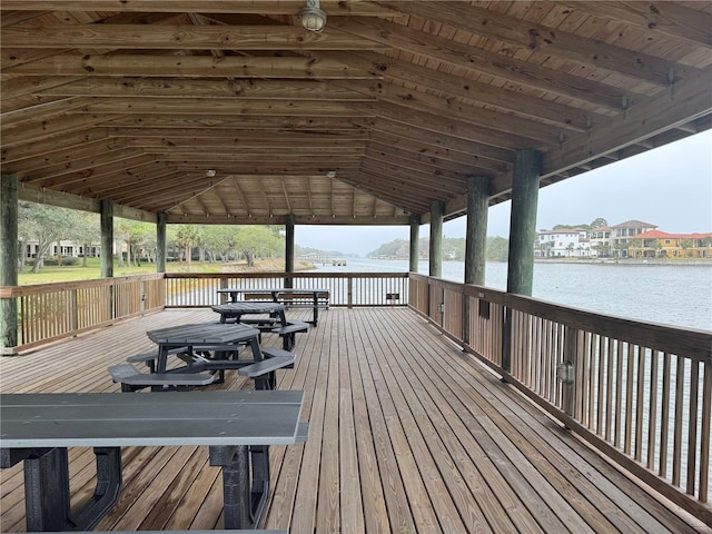 view of dock with a gazebo and a deck with water view