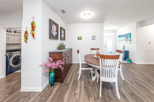 dining area featuring washer / dryer and dark wood-type flooring