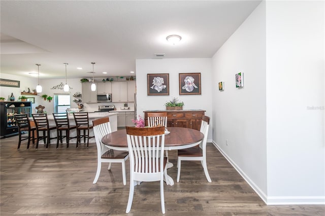 dining space featuring dark wood-type flooring