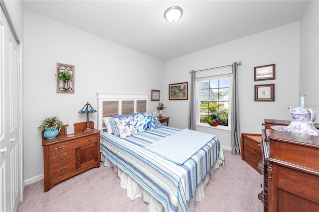 carpeted bedroom with a closet