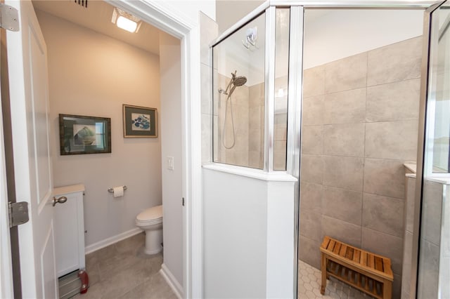 bathroom with toilet, tile patterned floors, and an enclosed shower