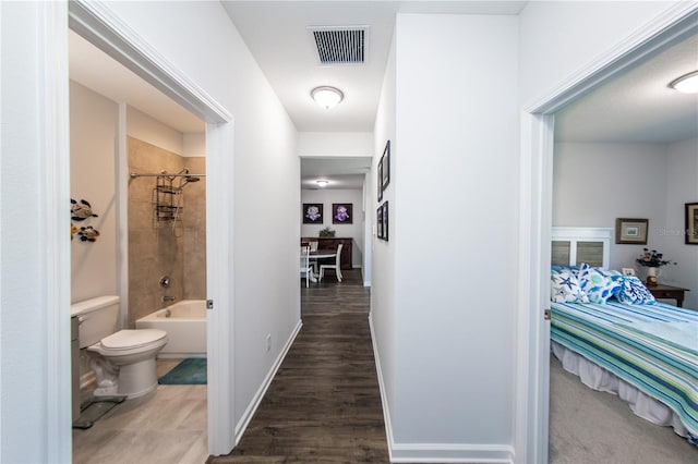 corridor with wood-type flooring