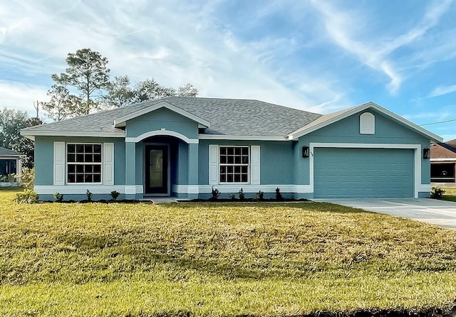 view of front of property with a garage and a front lawn