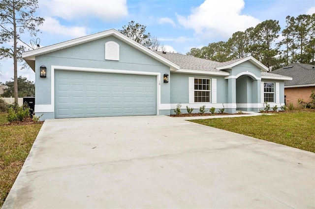 single story home with a garage and a front yard