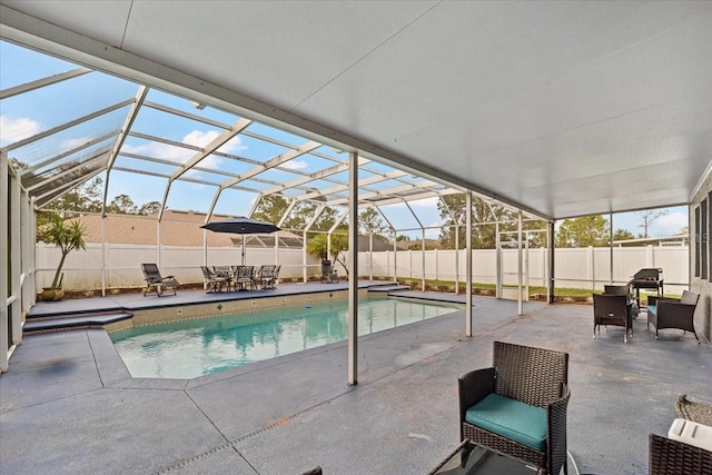 view of swimming pool featuring a lanai and a patio