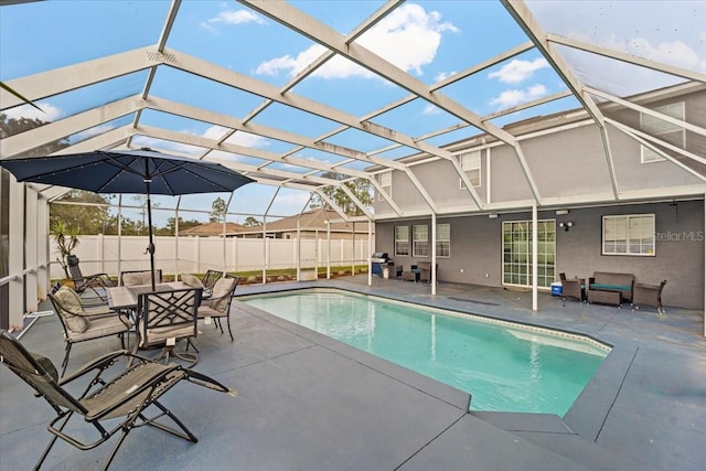 view of swimming pool with glass enclosure and a patio area