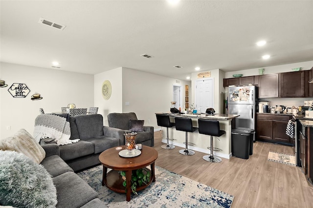 living room with light hardwood / wood-style flooring