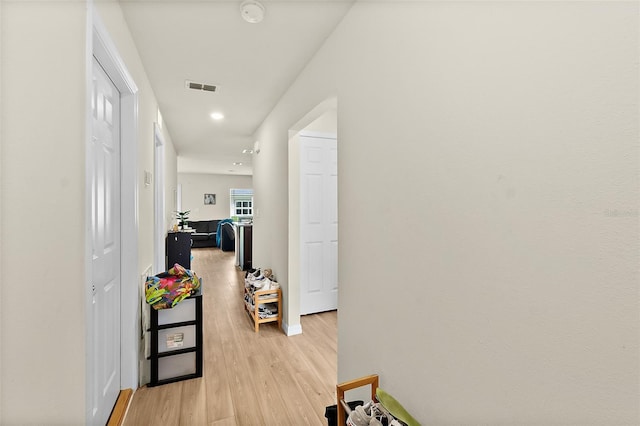 corridor with light hardwood / wood-style floors