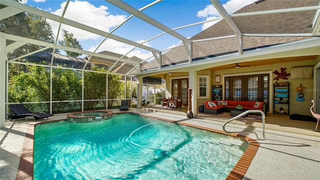 view of pool with ceiling fan, a patio, a lanai, french doors, and an in ground hot tub