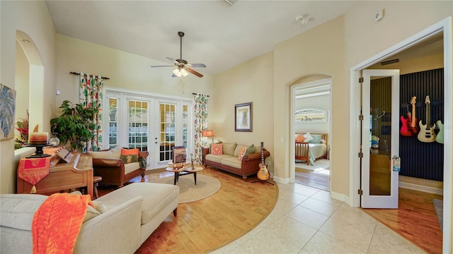 living room with french doors, light hardwood / wood-style floors, and ceiling fan