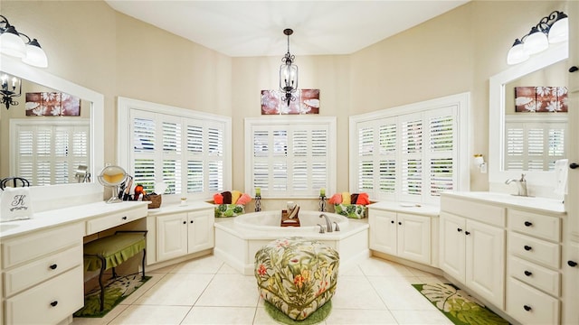 bathroom with vanity, tile patterned floors, an inviting chandelier, and a bathing tub