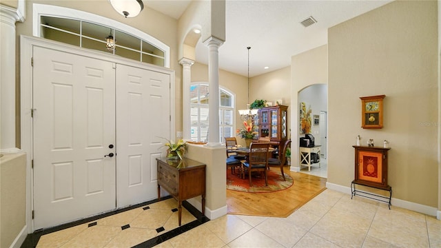 tiled foyer with decorative columns