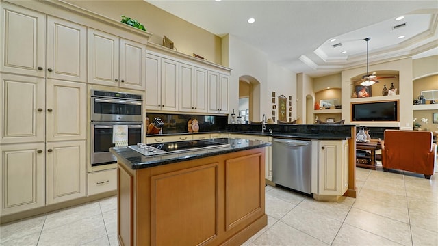 kitchen featuring a center island, cream cabinets, stainless steel appliances, and built in shelves