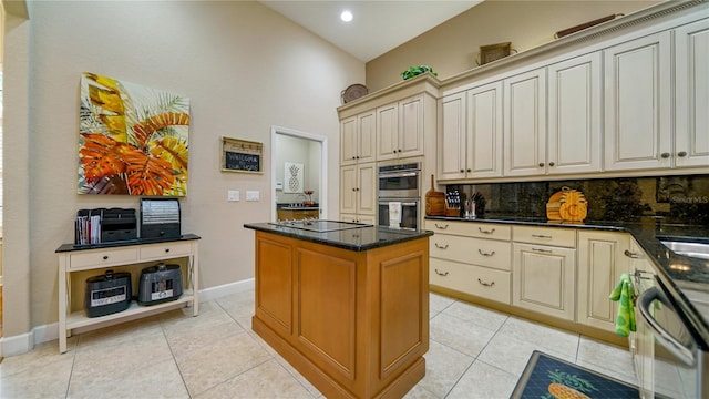 kitchen featuring dishwasher, backsplash, stainless steel double oven, vaulted ceiling, and light tile patterned floors