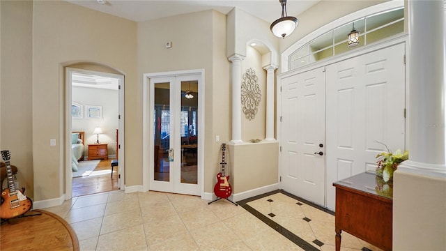 tiled entryway with french doors and decorative columns