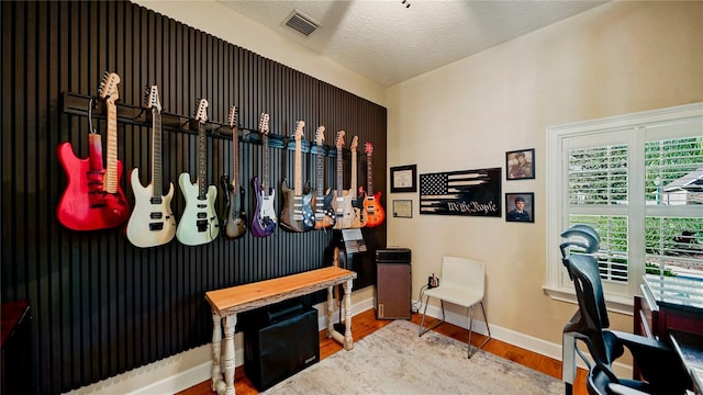 interior space featuring a textured ceiling and hardwood / wood-style flooring