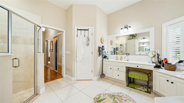 bathroom featuring vanity, an enclosed shower, and tile patterned floors