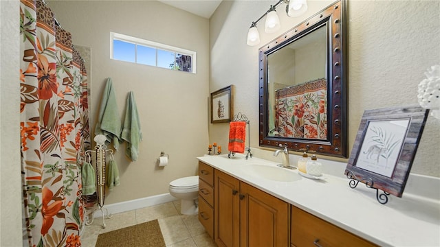 bathroom featuring vanity, toilet, and tile patterned flooring