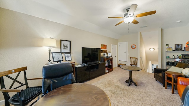 carpeted living room featuring ceiling fan