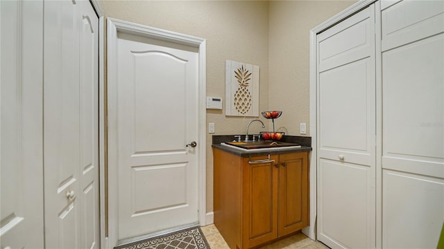 interior space featuring sink and light tile patterned floors