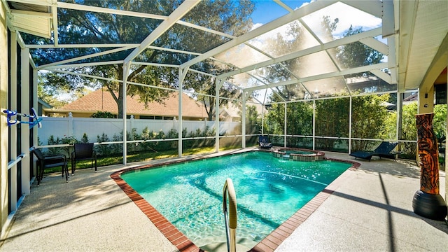 view of pool with a patio, a lanai, and an in ground hot tub