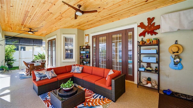 living room with ceiling fan, a healthy amount of sunlight, and wooden ceiling