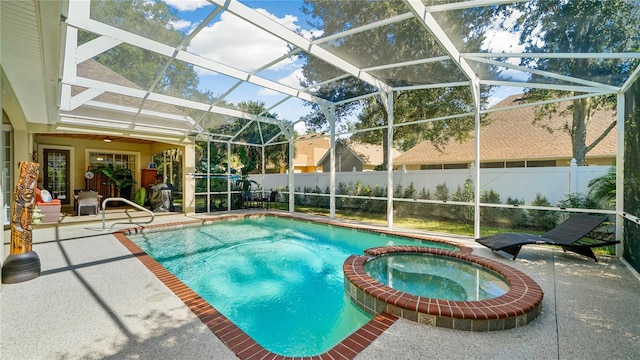 view of swimming pool with a patio, an in ground hot tub, and glass enclosure