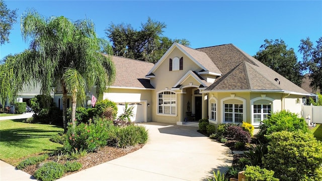 view of front of home featuring a front yard and a garage