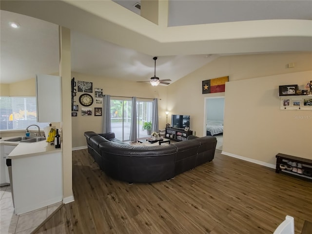 living room featuring ceiling fan, vaulted ceiling, sink, and dark hardwood / wood-style flooring