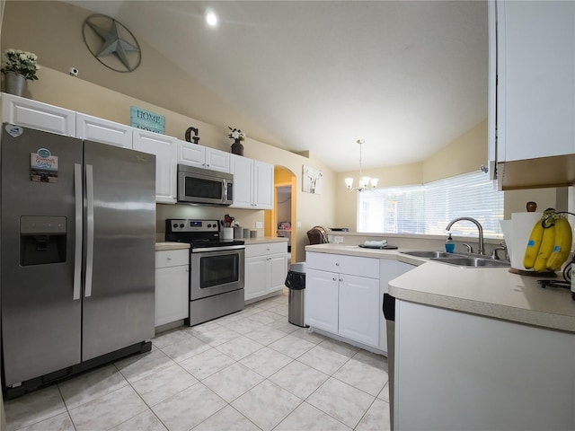 kitchen with sink, white cabinetry, stainless steel appliances, lofted ceiling, and decorative light fixtures