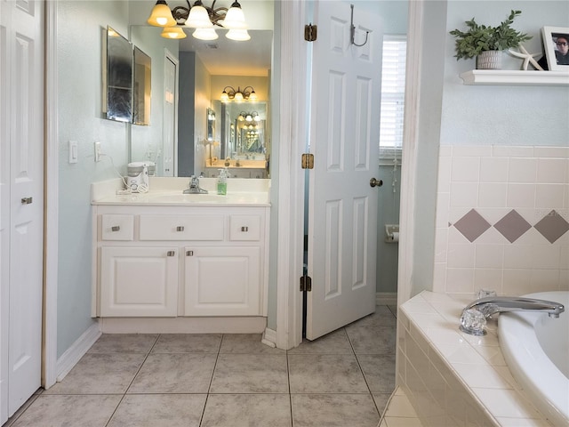 bathroom featuring vanity, tile patterned flooring, and tiled bath