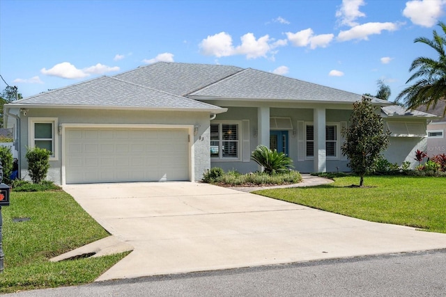 view of front facade with a garage and a front lawn