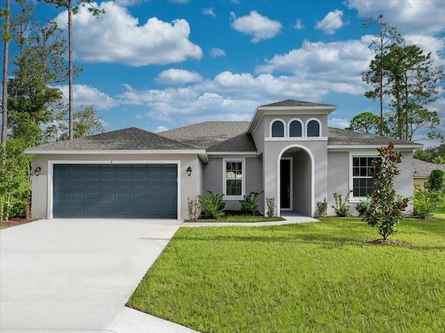 mediterranean / spanish-style house featuring a front lawn and a garage