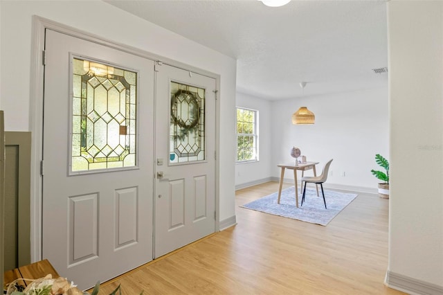 entryway with light hardwood / wood-style floors