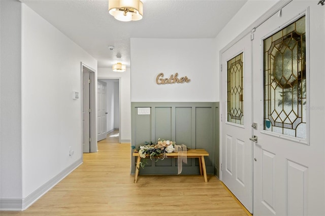 interior space with light hardwood / wood-style floors and a textured ceiling