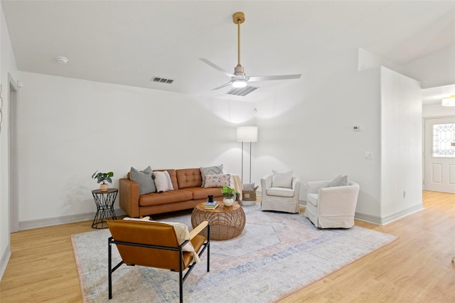 living room with ceiling fan and light hardwood / wood-style flooring