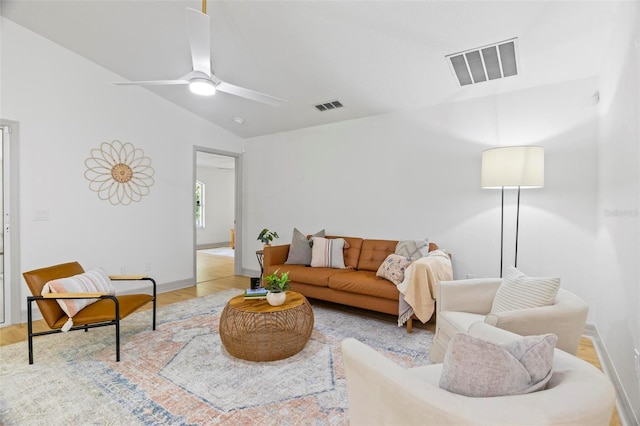 living room featuring ceiling fan and vaulted ceiling