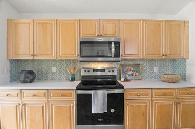 kitchen with backsplash, appliances with stainless steel finishes, and light brown cabinetry