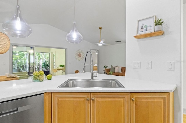 kitchen featuring sink, ceiling fan, lofted ceiling, pendant lighting, and stainless steel dishwasher